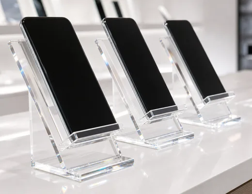 Acrylic cell phone display stands on a carrier retail phone wall with demo units