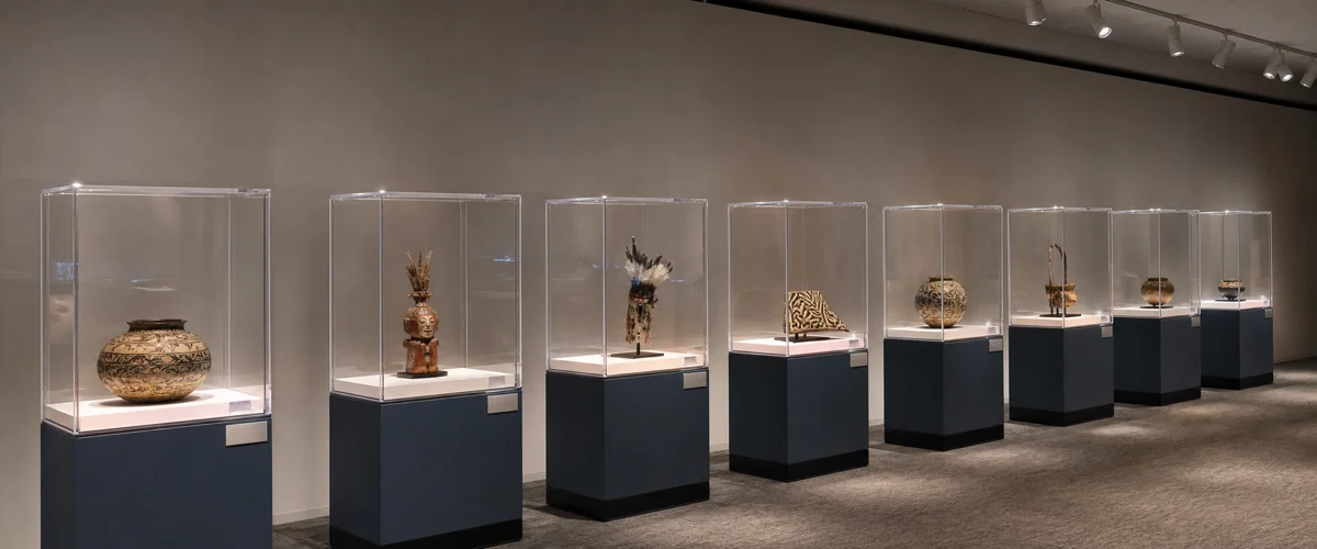 8 archival-grade UV-protected museum-glaze acrylic display cases with under-5% UV transmission produced for a 4-month regional-museum traveling exhibit