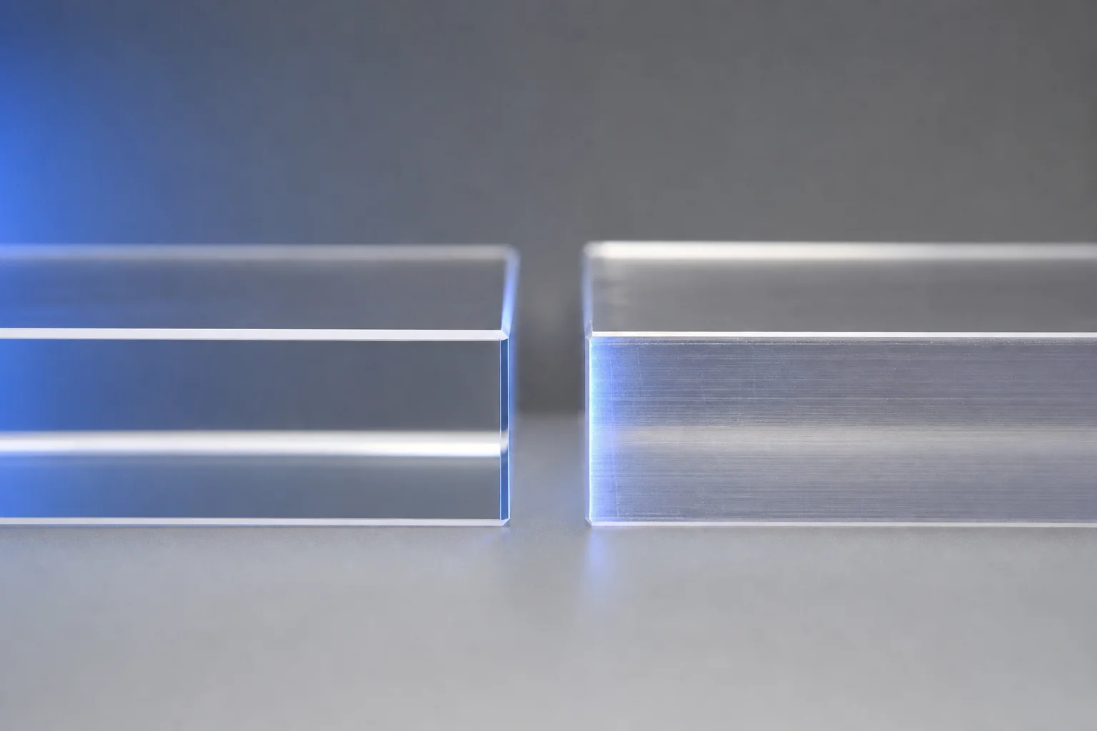 Two acrylic sheet samples side-by-side showing edge clarity difference between cast and extruded