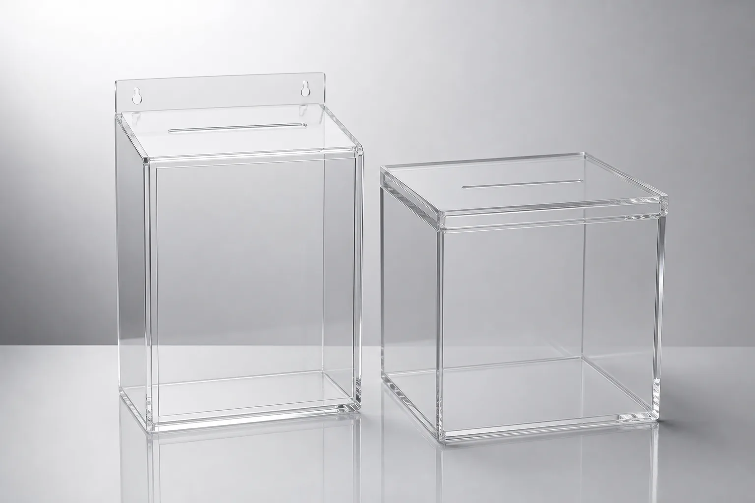 Wall-mounted acrylic suggestion box with a printed panel beside a clear acrylic raffle entry box on a counter