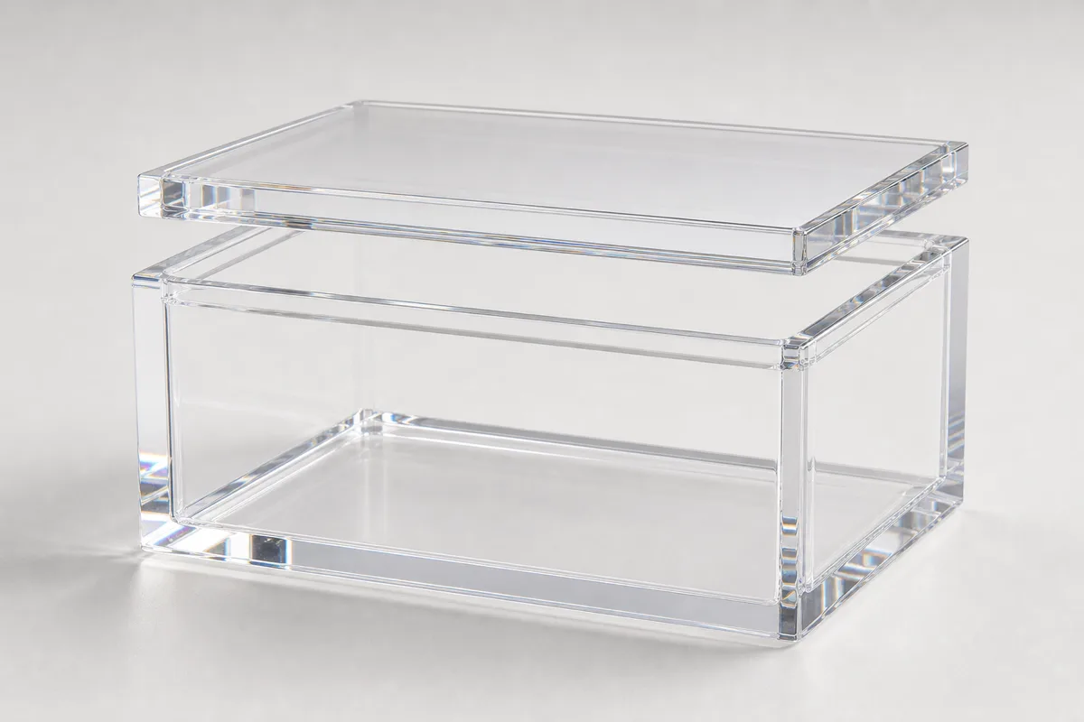 Custom clear acrylic boxes with lids — a lift-off lidded cube, a hinged-lid box, and a slide-on-lid box in optical-clear cast acrylic