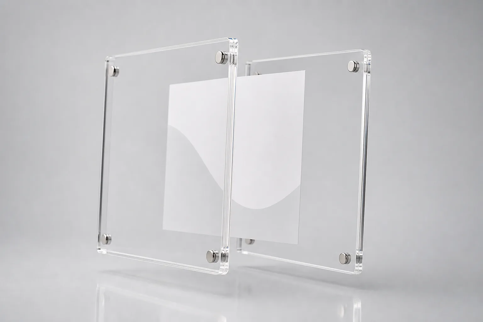 Acrylic magnetic frame with two panels partly separated showing corner neodymium magnets and a photo insert about to be clamped