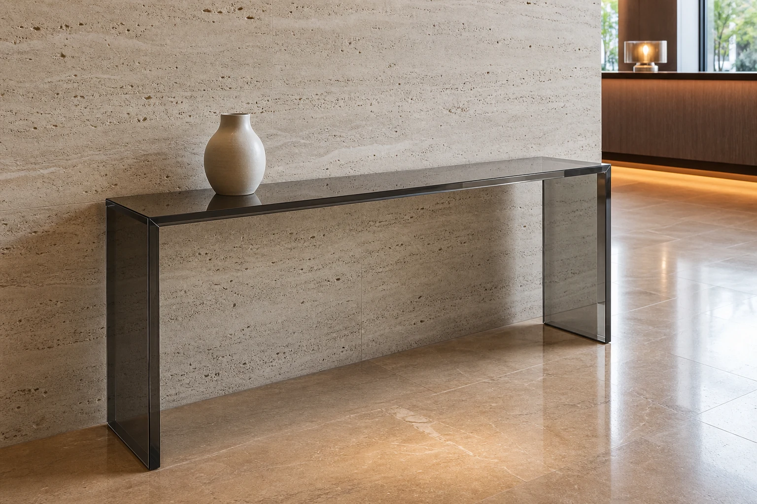 Long rectangular clear cast acrylic console table wall-aligned in a hotel lobby corridor