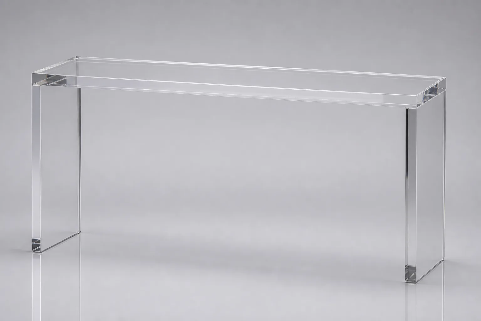 Long narrow clear acrylic console table standing against a wall in a hotel lobby corridor, with mirror-polished edges