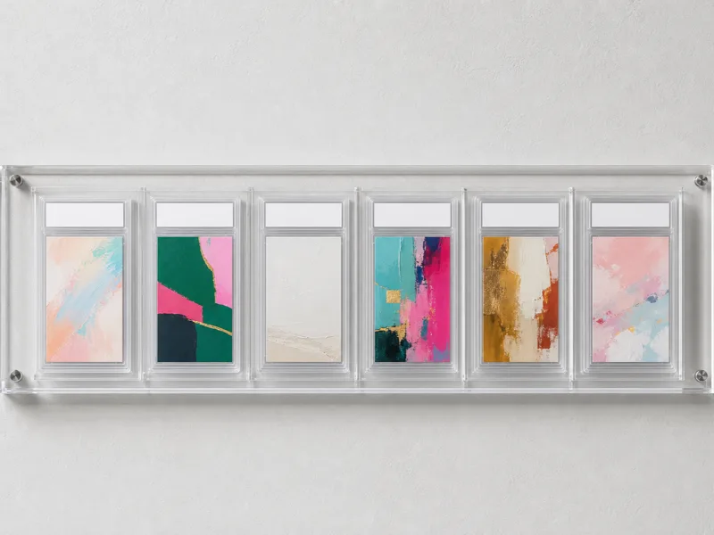 Wall-mounted clear acrylic vertical-slot slab rack panel holding a row of encapsulated graded card slabs