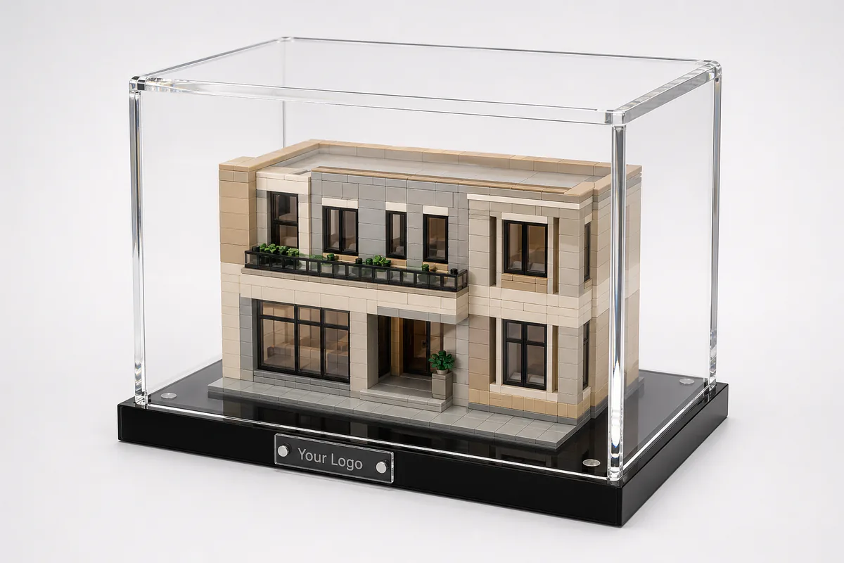 Custom clear acrylic LEGO display case with UV-filtering walls, magnetic lid, and branded plaque on a black acrylic base